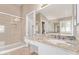 Bathroom featuring granite counters, double sinks, walk-in shower and large vanity mirror at 4100 S Dewdrop Ct, Gilbert, AZ 85297