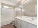 Bright bathroom featuring a double sink vanity and a shower-tub combo at 4100 S Dewdrop Ct, Gilbert, AZ 85297