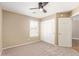 Bedroom featuring neutral walls, plush carpet, plantation shutters, and a ceiling fan at 4100 S Dewdrop Ct, Gilbert, AZ 85297