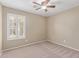 Neutral bedroom featuring plush carpet and a ceiling fan for comfort at 4100 S Dewdrop Ct, Gilbert, AZ 85297