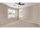 Well-lit bedroom featuring plush carpet and bright windows at 4100 S Dewdrop Ct, Gilbert, AZ 85297