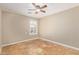 Bedroom featuring neutral walls, tile flooring, plantation shutters, and a ceiling fan at 4100 S Dewdrop Ct, Gilbert, AZ 85297