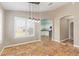 Open dining room features tile floors, large windows, neutral walls, and view of modern white kitchen at 4100 S Dewdrop Ct, Gilbert, AZ 85297