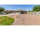 Single-story home featuring desert landscaping, stone accents, two-car garage, gated side yard, and neutral color scheme at 4100 S Dewdrop Ct, Gilbert, AZ 85297