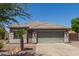 Single-story home with desert landscaping, neutral color scheme, a two-car garage, and a tiled roof at 4100 S Dewdrop Ct, Gilbert, AZ 85297