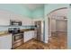 Bright kitchen features stainless steel appliances, granite countertops, and stylish tile flooring at 4100 S Dewdrop Ct, Gilbert, AZ 85297