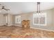 Open living room offers natural light, tile floors, and a stylish stone accent wall at 4100 S Dewdrop Ct, Gilbert, AZ 85297