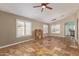 Open-concept living room features tile flooring, natural light, neutral walls, and ceiling fan at 4100 S Dewdrop Ct, Gilbert, AZ 85297