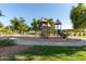 Community playground with slides, swings, and climbing structures surrounded by green grass at 4100 S Dewdrop Ct, Gilbert, AZ 85297
