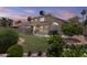Large backyard with a lush lawn and mature landscaping at 4306 E Amberwood Dr, Phoenix, AZ 85048