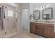 Bathroom features a glass shower, double sinks, and modern fixtures at 4306 E Amberwood Dr, Phoenix, AZ 85048