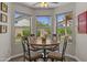 Cozy breakfast nook with backyard views and a ceiling fan at 4306 E Amberwood Dr, Phoenix, AZ 85048