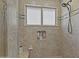 Tiled shower with built-in shelves and rainfall shower head at 4306 E Amberwood Dr, Phoenix, AZ 85048