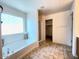 Bright bathroom with large soaking tub and walk-in shower at 44147 W Snow Dr, Maricopa, AZ 85138
