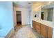 Bathroom featuring double sink, walk-in shower, and ample cabinet space at 44147 W Snow Dr, Maricopa, AZ 85138