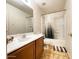 Bathroom with a sink, mirror, toilet, bathtub, and shower with tan cabinets at 44147 W Snow Dr, Maricopa, AZ 85138