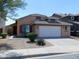 Charming single-Gathering home featuring desert landscaping and a two-car garage at 44147 W Snow Dr, Maricopa, AZ 85138