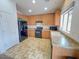 Functional kitchen with oak cabinets, black appliances, and durable countertops at 44147 W Snow Dr, Maricopa, AZ 85138