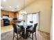 Eat in kitchen area with pendant lighting and sliding door at 44147 W Snow Dr, Maricopa, AZ 85138