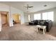 Bright living room with neutral carpet, offering a flexible space for relaxation and entertainment at 44147 W Snow Dr, Maricopa, AZ 85138