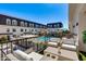 Relax on this outdoor balcony with lounge seating, overlooking the community pool on a beautiful sunny day at 4438 N 27Th St # 27, Phoenix, AZ 85016