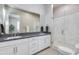 Modern bathroom featuring double sinks, a large mirror, and a walk-in shower with sleek glass doors at 4438 N 27Th St # 27, Phoenix, AZ 85016