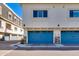 Townhome garages with bright blue doors, and stone accents at 4438 N 27Th St # 27, Phoenix, AZ 85016