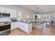 Open concept kitchen with stainless steel appliances and breakfast bar, leading to the dining and living area at 4438 N 27Th St # 27, Phoenix, AZ 85016