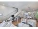 Spacious open-concept living area with modern staircase, desk and adjacent dining and kitchen at 4438 N 27Th St # 27, Phoenix, AZ 85016