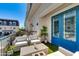 Inviting outdoor patio area with stylish seating, a coffee table, and blue double doors at 4438 N 27Th St # 27, Phoenix, AZ 85016