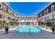 Community pool with lounge chairs and lush landscaping nestled between townhomes at 4438 N 27Th St # 27, Phoenix, AZ 85016