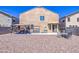 The back of this home has low maintenance landscaping, patio, BBQ, and fire pit at 46057 W Dutchman Dr, Maricopa, AZ 85139