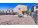 The back of this home has low maintenance landscaping, patio, BBQ, and fire pit at 46057 W Dutchman Dr, Maricopa, AZ 85139