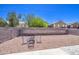 This backyard features a gravel ground cover and block fencing for privacy at 46057 W Dutchman Dr, Maricopa, AZ 85139