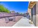 This backyard has low maintenance ground cover, patio, BBQ, and fire pit at 46057 W Dutchman Dr, Maricopa, AZ 85139