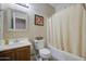 Bright bathroom features a shower-tub combo with neutral tiling at 46057 W Dutchman Dr, Maricopa, AZ 85139