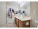 Well-lit bathroom featuring double sinks with dark cabinets at 46057 W Dutchman Dr, Maricopa, AZ 85139