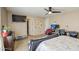A bedroom featuring a large TV, comfortable bed, and a walk-in closet at 46057 W Dutchman Dr, Maricopa, AZ 85139