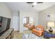 Cozy bedroom showcases closet with mirrored sliding doors, ceiling fan, and sitting area at 46057 W Dutchman Dr, Maricopa, AZ 85139