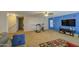 A spacious bonus room features carpet, a ceiling fan, neutral walls, and access to stairs at 46057 W Dutchman Dr, Maricopa, AZ 85139