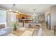 Bright dining area with rustic table that connects to the modern kitchen with stainless steel appliances at 46057 W Dutchman Dr, Maricopa, AZ 85139