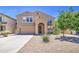 Charming two-story home featuring a well-maintained yard, two car garage, and covered front entrance at 46057 W Dutchman Dr, Maricopa, AZ 85139