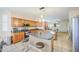Bright kitchen featuring wood cabinetry, modern appliances, and a convenient center island with seating at 46057 W Dutchman Dr, Maricopa, AZ 85139