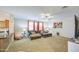 Inviting open-concept living room featuring a comfortable seating arrangement and natural light at 46057 W Dutchman Dr, Maricopa, AZ 85139