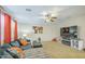 Inviting living room featuring a plush couch, ceiling fan, and a modern entertainment center at 46057 W Dutchman Dr, Maricopa, AZ 85139