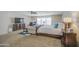 Large main bedroom showcasing a king bed, comfortable seating, and ample natural light at 46057 W Dutchman Dr, Maricopa, AZ 85139