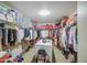 Well-organized walk-in closet with shelving, hanging space, and central island at 46057 W Dutchman Dr, Maricopa, AZ 85139