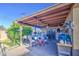 This cozy, covered patio features ample storage and furniture, perfect for enjoying the outdoors at 4727 N 50Th Dr, Phoenix, AZ 85031