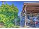 The covered patio features storage and furniture, complemented by a lush tree providing shade at 4727 N 50Th Dr, Phoenix, AZ 85031