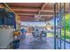 The cozy, covered patio includes a ceiling fan, furniture, and an iron gate at 4727 N 50Th Dr, Phoenix, AZ 85031